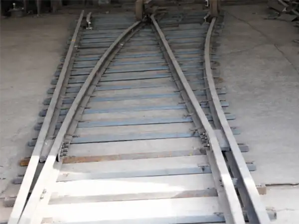 technicians-testing-narrow-gauge-tourist-train-turnout-system-in-factory